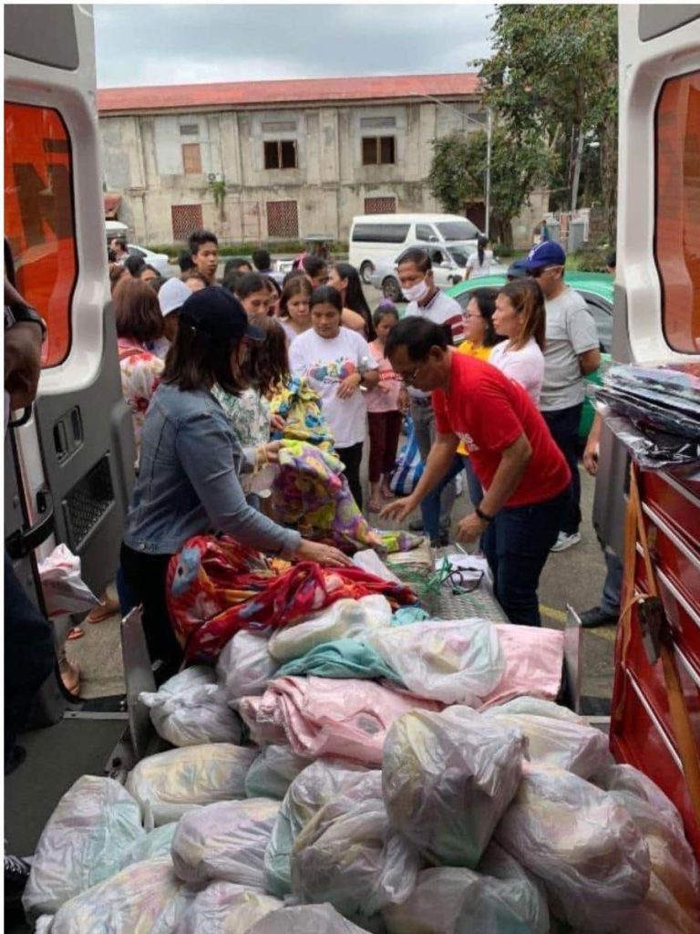 Ayala employees distribute emergency items from a KTM van 