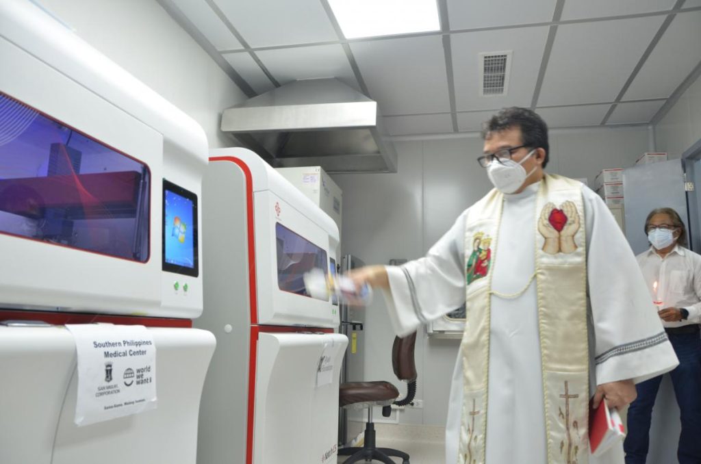 A priest blesses the medical equipment for COVID-19 testing donated by the Ayala group to Southern Philippines Medical Center.